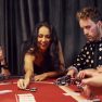 Group of elegant young people that playing poker in casino together Group of elegant young people that playing poker in casino together