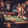 Upper class friends gambling in a casino Upper class friends gambling in a casino